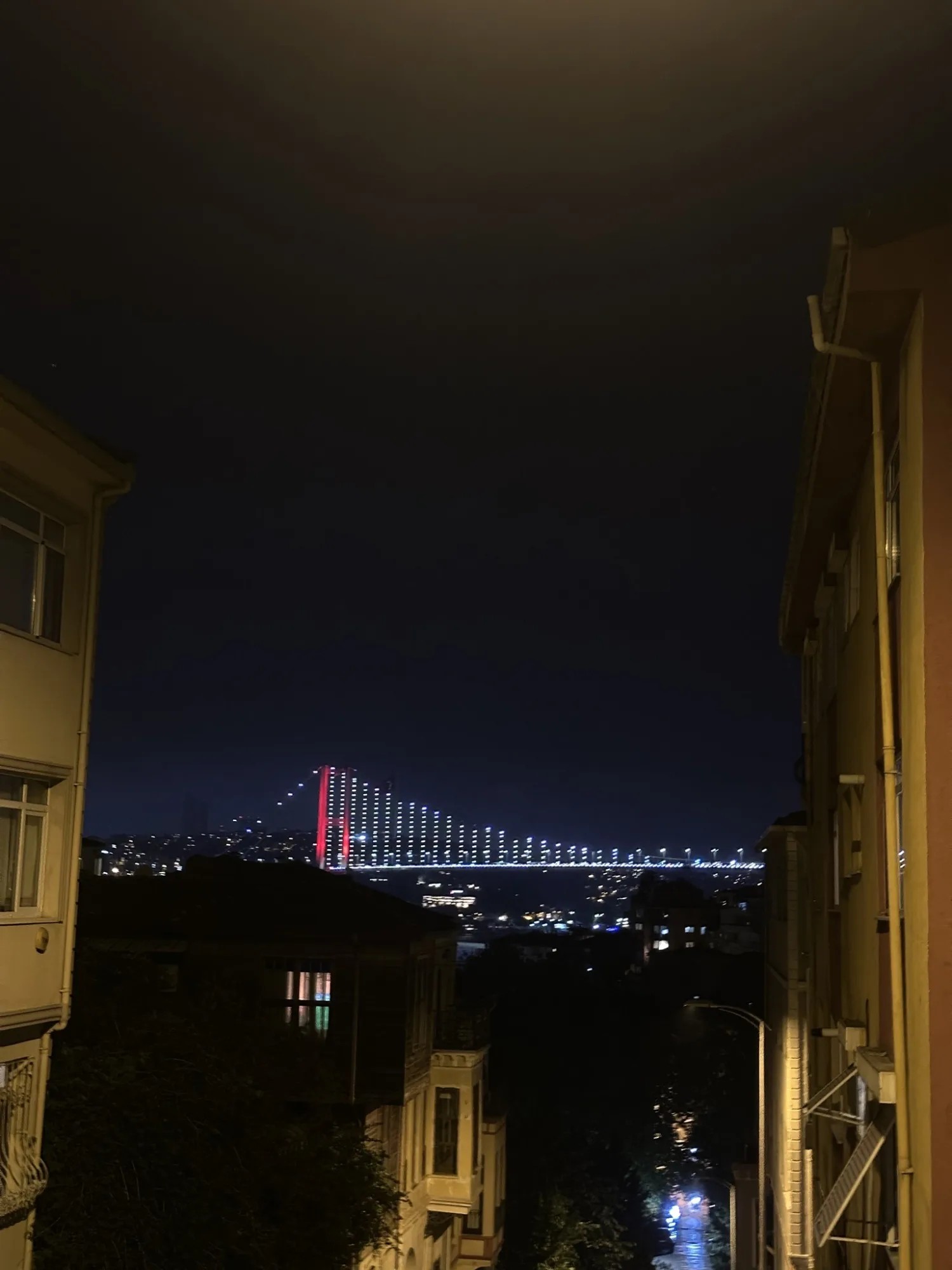 A quiet evening descends, the city lights reflecting a gentle glow.